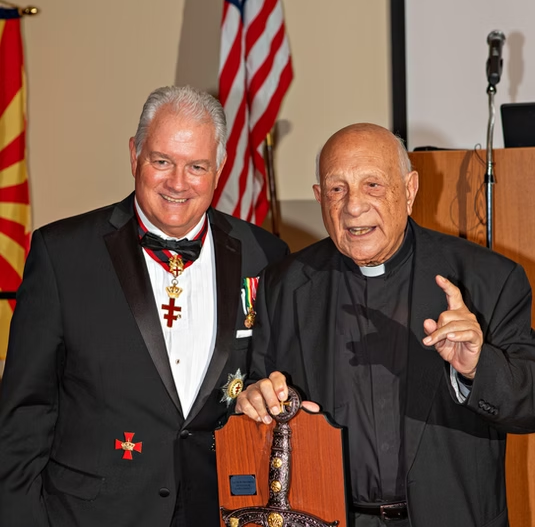 Two gala attendees presenting an engraved award at the Templar Gala